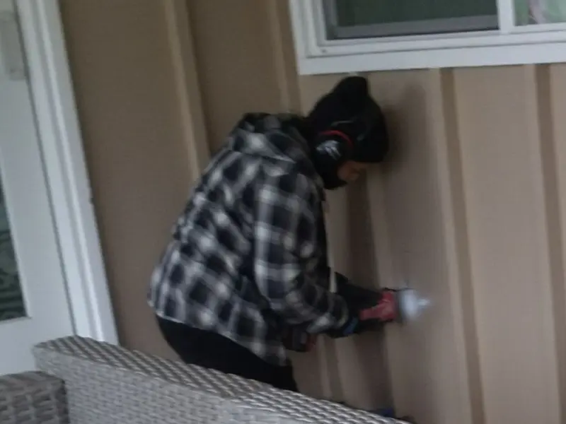 Professional electrician installing an exterior outlet in Marlboro